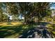 Scenic park with picnic tables and walking path, surrounded by lush trees and landscaping at 833 Lakeside Ter, Palm Harbor, FL 34683