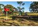 Colorful playground with slides and climbing structures, nestled in a grassy park setting at 833 Lakeside Ter, Palm Harbor, FL 34683