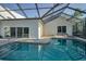 Enjoy the large screened pool, brick paver deck and sliding glass doors creating an inviting indoor/outdoor flow at 833 Lakeside Ter, Palm Harbor, FL 34683
