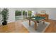 Recreation room with a pool table and access to the screened-in pool at 833 Lakeside Ter, Palm Harbor, FL 34683