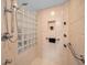 Walk-in shower with seating, hand rails, and custom glass block for natural light at 833 Lakeside Ter, Palm Harbor, FL 34683