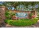 The brick entrance sign for Westlake Village is surrounded by lush landscaping at 833 Lakeside Ter, Palm Harbor, FL 34683