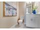 Modern half bathroom with white vanity, commode, and stylish decor at 845 Steel Dr, Apollo Beach, FL 33572