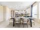 Elegant dining room with modern chandelier, white walls, and view into the kitchen at 845 Steel Dr, Apollo Beach, FL 33572
