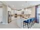 Modern kitchen featuring stainless steel appliances, island with breakfast bar, and stylish pendant lighting at 845 Steel Dr, Apollo Beach, FL 33572