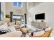 Living room featuring high ceilings, modern furnishings, a large sectional, and outdoor views at 845 Steel Dr, Apollo Beach, FL 33572