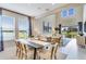 Open-concept living and dining room with modern furnishings, tile flooring, and lots of natural light at 845 Steel Dr, Apollo Beach, FL 33572
