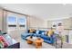 Upstairs loft featuring a comfortable seating area with a blue sectional sofa and windows at 845 Steel Dr, Apollo Beach, FL 33572