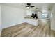 View of the light-filled living room showcasing the open layout, wood floors, and modern fixtures at 9230 Wood Dr, Hudson, FL 34667