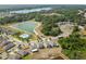 Aerial view features a community with lake, swimming pool and modern single Gathering homes at 10013 Caraway Spice Ave, Riverview, FL 33578