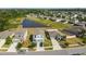 Aerial view featuring modern homes, landscaped yards, and a tranquil pond at 10013 Caraway Spice Ave, Riverview, FL 33578