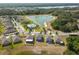 Aerial view showcases a community with a lake, pool, and attractive landscaping at 10013 Caraway Spice Ave, Riverview, FL 33578