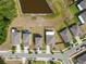 Aerial view showcases a new neighborhood with backyard, well-manicured lawns and neighborhood street at 10013 Caraway Spice Ave, Riverview, FL 33578