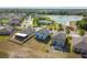 Aerial view showcases a neighborhood with lake views and community pool at 10013 Caraway Spice Ave, Riverview, FL 33578