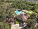Aerial view of community amenities, featuring a sparkling pool, a playground, and meticulously maintained landscaping and plenty of parking at 10013 Caraway Spice Ave, Riverview, FL 33578