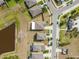 Aerial view of new homes in a neighborhood with backyard, well-manicured lawns and neighborhood street at 10013 Caraway Spice Ave, Riverview, FL 33578
