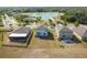 Aerial view of backyard, landscaping, lake and community amenities including a pool at 10013 Caraway Spice Ave, Riverview, FL 33578