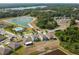 Community aerial view with large lake, swimming pool, modern homes and lush landscaping at 10013 Caraway Spice Ave, Riverview, FL 33578