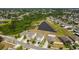 Aerial view of a neighborhood with pond, showcasing lush greenery at 10013 Caraway Spice Ave, Riverview, FL 33578