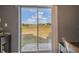 View of the spacious backyard, seen through sliding glass doors, offering plenty of space and natural light at 10013 Caraway Spice Ave, Riverview, FL 33578