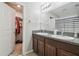 Bathroom with granite countertop, double vanity, and a walk-in closet at 10013 Caraway Spice Ave, Riverview, FL 33578