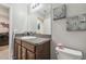 Bathroom with granite countertop vanity, mirror, and decorative seashell and starfish wall art at 10013 Caraway Spice Ave, Riverview, FL 33578
