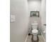Bathroom featuring toilet, shelf with extra toilet paper, and cleaning supplies at 10013 Caraway Spice Ave, Riverview, FL 33578
