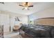 Bedroom with a ceiling fan, a large bed, a chair, and a window, creating a serene living space at 10013 Caraway Spice Ave, Riverview, FL 33578