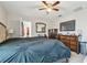 Bright bedroom featuring a ceiling fan, a TV, and a dresser, creating a comfortable living space at 10013 Caraway Spice Ave, Riverview, FL 33578