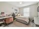 Bedroom featuring a twin bed with a patterned bedspread, a desk area, and a window with sheer curtains at 10013 Caraway Spice Ave, Riverview, FL 33578