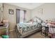 Bedroom featuring a bed with colorful butterfly pattern bedding, gray curtains, and a silver dresser at 10013 Caraway Spice Ave, Riverview, FL 33578