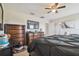Comfortable bedroom featuring ceiling fan, dressers, TV and bed for cozy living space at 10013 Caraway Spice Ave, Riverview, FL 33578