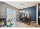 Cozy dining area with modern lighting fixture and sliding glass doors to the backyard at 10013 Caraway Spice Ave, Riverview, FL 33578
