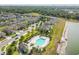 Avelar Creek community aerial view showcases pool and residential area, lush greenery, and serene water features at 10013 Caraway Spice Ave, Riverview, FL 33578