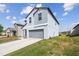 Two-story home boasts a modern design, two-car garage, and well-manicured lawn in a suburban neighborhood at 10013 Caraway Spice Ave, Riverview, FL 33578