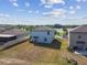 Two-story home showing backyard near a lake, blue sky, and puffy white clouds at 10013 Caraway Spice Ave, Riverview, FL 33578