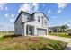 Two-story home boasts a modern design, two-car garage, and well-manicured lawn in a suburban neighborhood at 10013 Caraway Spice Ave, Riverview, FL 33578