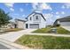 Two-story home boasts a modern design, two-car garage, and well-manicured lawn in a suburban neighborhood at 10013 Caraway Spice Ave, Riverview, FL 33578