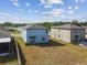 Aerial view of a two-story home with a spacious backyard near a lake at 10013 Caraway Spice Ave, Riverview, FL 33578