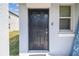 Inviting entryway with dark front door, decorative welcome sign, and modern exterior finishes at 10013 Caraway Spice Ave, Riverview, FL 33578