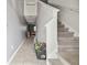 Bright hallway featuring tile flooring, staircase, and neutral paint, creating a welcoming entry at 10013 Caraway Spice Ave, Riverview, FL 33578