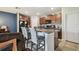 Kitchen featuring dark cabinetry, granite counters, stainless steel appliances, and bar seating at 10013 Caraway Spice Ave, Riverview, FL 33578