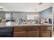 Open kitchen with granite countertops, dark wood cabinets, and a view into the living area at 10013 Caraway Spice Ave, Riverview, FL 33578