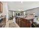Kitchen island featuring granite countertops, seamlessly flowing into the living area at 10013 Caraway Spice Ave, Riverview, FL 33578