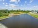 Scenic view of a lake surrounded by lush greenery and a clear blue sky at 10013 Caraway Spice Ave, Riverview, FL 33578