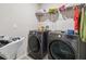 Laundry room showcasing a modern washer and dryer set, complemented by ample storage and organized shelving at 10013 Caraway Spice Ave, Riverview, FL 33578