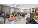 Open-concept living room with tile floors and a ceiling fan, seamlessly connected to the kitchen at 10013 Caraway Spice Ave, Riverview, FL 33578