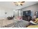 Bright living room with tile floors, a ceiling fan, and a cozy entertainment center at 10013 Caraway Spice Ave, Riverview, FL 33578