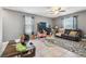 Comfortable living room featuring tile floors, ample natural light, and a ceiling fan at 10013 Caraway Spice Ave, Riverview, FL 33578