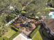 Aerial view of a fenced playground with mature trees and lush greenery creating a safe and inviting play area for families at 10013 Caraway Spice Ave, Riverview, FL 33578